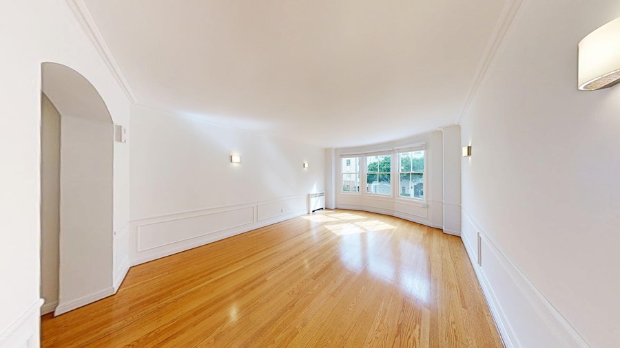 A room with wooden floors and white walls.